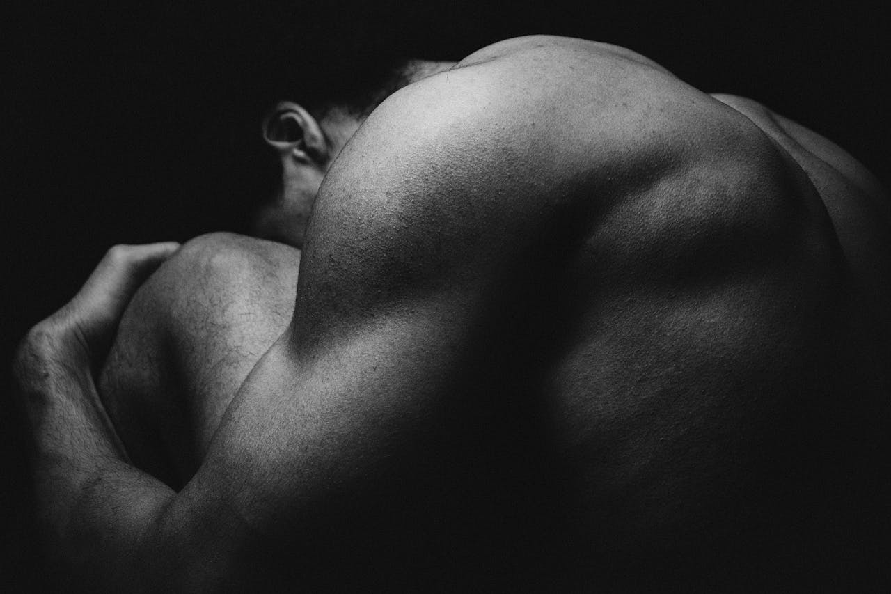 Black and White Photo of Muscular Back of a Man